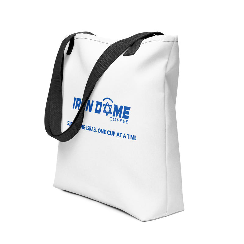 A white tote bag with black straps and blue text logo 'IRON DOME COFFEE' on the side.