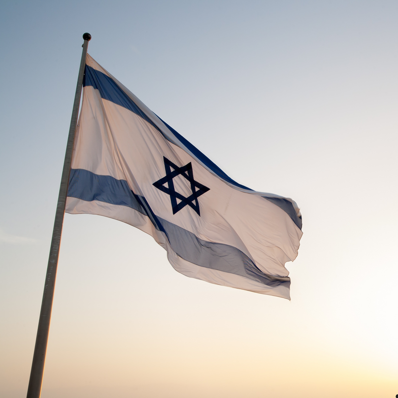 Israeli flag waving against a clear sky