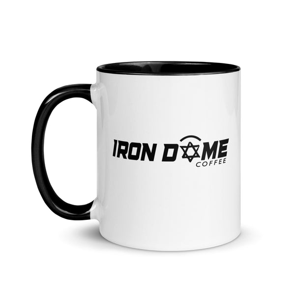 A ceramic coffee mug with a white body and black handle and interior. The mug features text 'IRON DOME COFFEE' on the side.