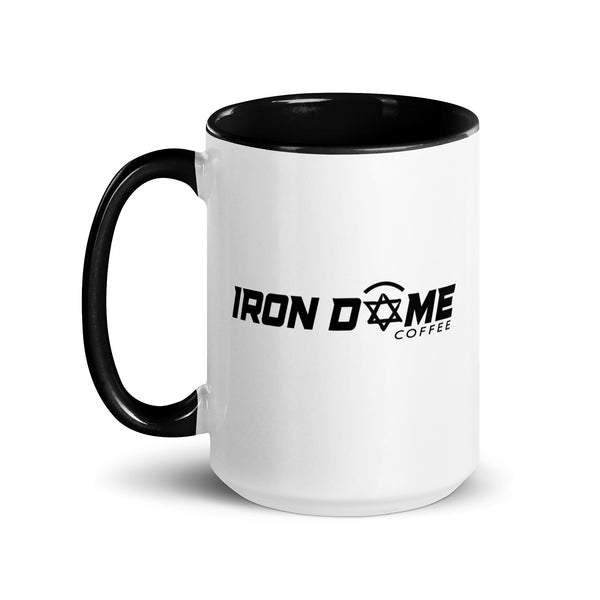 A ceramic coffee mug with a white body and black handle and interior. The mug features text 'IRON DOME COFFEE' on the side.